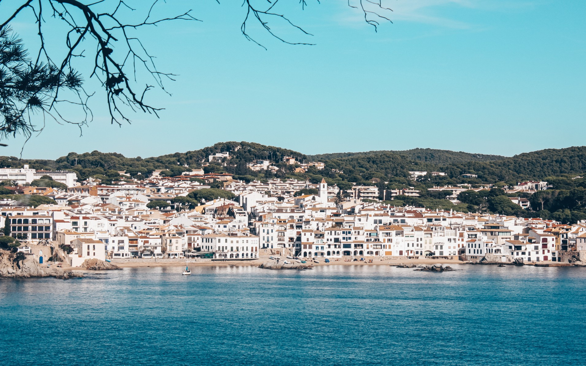 White-washed Cadaqués village nestled along the Mediterranean shoreline